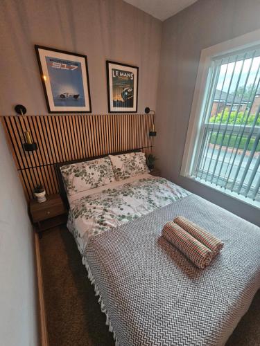 a bedroom with a bed and a window at Hillsome Hosting Wigan in Pemberton