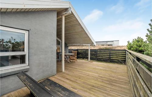 a wooden deck on the side of a house at Amazing Home In Thisted With Sauna in Torsted
