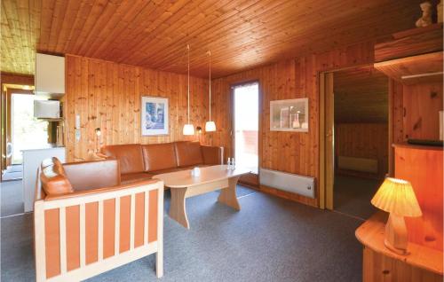 a living room with a couch and a table at Holiday Home Svenstibakkevej Frøstrup Iv in Lild Strand