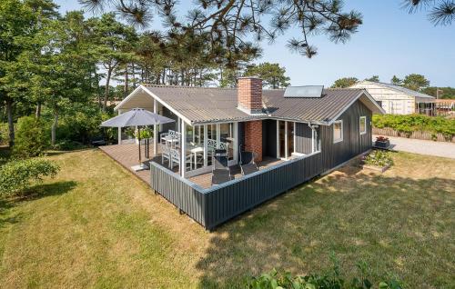 a small house with a deck in a yard at Beautiful Home In Ebeltoft With Wifi in Ebeltoft