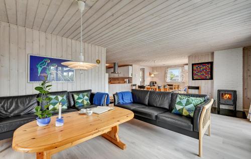 a living room with a couch and a table at Beautiful Home In Ebeltoft With Wifi in Ebeltoft
