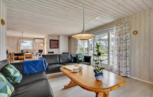 a living room with a couch and a table at Beautiful Home In Ebeltoft With Wifi in Ebeltoft