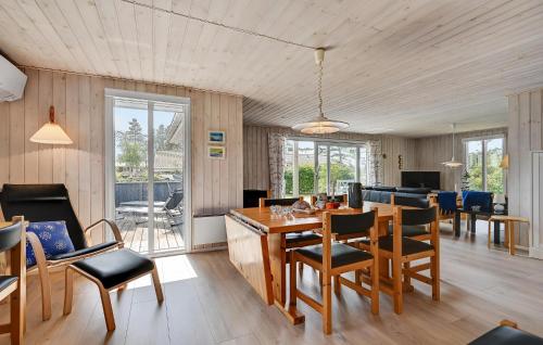 a dining room and living room with a table and chairs at Beautiful Home In Ebeltoft With Wifi in Ebeltoft