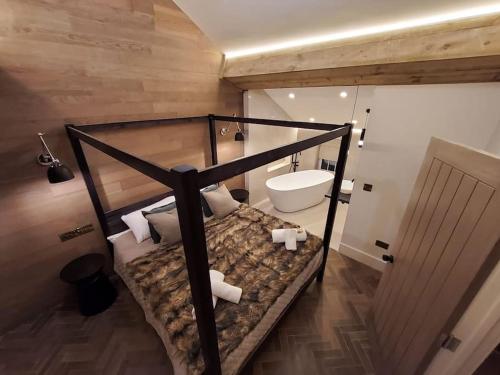 a bathroom with a bunk bed and a toilet at Tudor Cottage, Hot Tub, Sleeps 8 in Llandudno