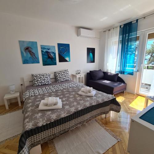 a bedroom with a large bed and a couch at Aurora in Rijeka