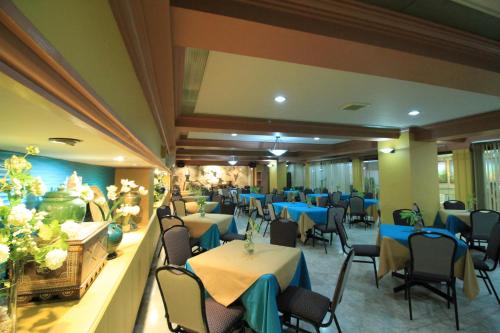 a dining room with tables and chairs and blue tables at Grand City Hotel Inc. in Cagayan de Oro