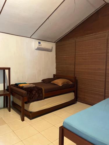 a bedroom with a bed in a room at Olala Bungalows and Restaurant in Sabong