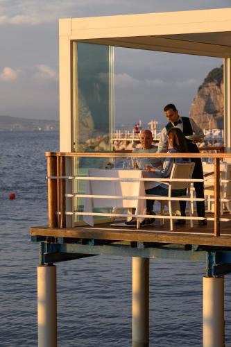 a group of people sitting on a deck of a boat at Parco dei Principi in Sorrento