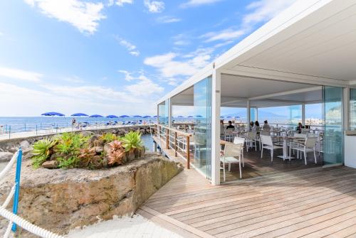 a restaurant on the beach with a view of the ocean at Parco dei Principi in Sorrento