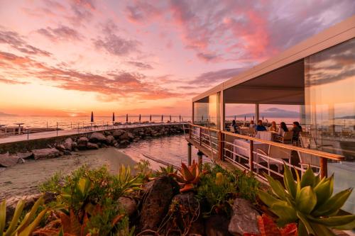 a rendering of a restaurant overlooking the ocean at sunset at Parco dei Principi in Sorrento