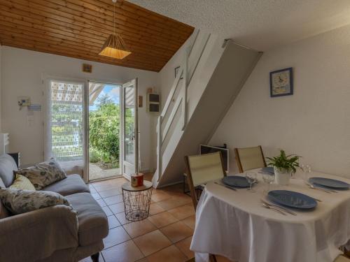 a living room with a table and a couch at Holiday Home Les Jardins de l'Océan-2 by Interhome in Pontaillac