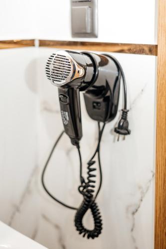 a blow dryer is hanging on a wall at Elegant Apartments in Poznań