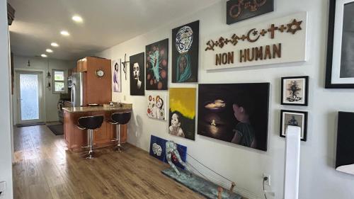 a room with a bunch of pictures on the wall at Llano Atelier in Miami