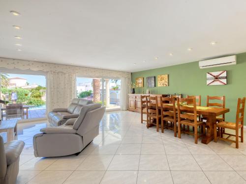 a living room with a table and a dining room at Holiday Home Llobregat 41b by Interhome in Empuriabrava