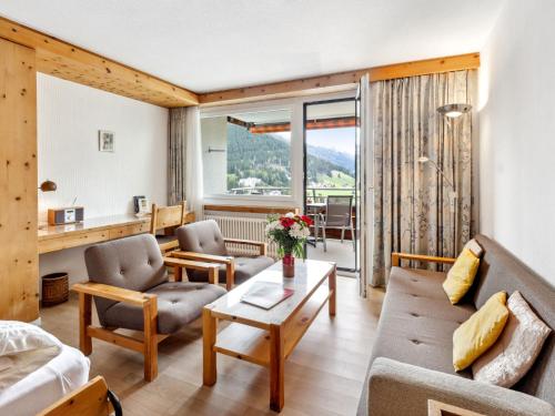 a living room with a couch and a table at Apartment Guardaval Apt 107 by Interhome in Davos