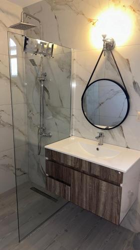 a bathroom with a sink and a mirror at Greek Mansion in Nea Moudania