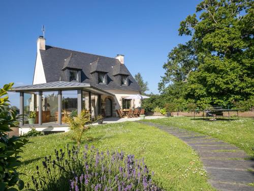 a house with a garden and a walkway at Holiday Home Les Menhirs by Interhome in Ploumilliau