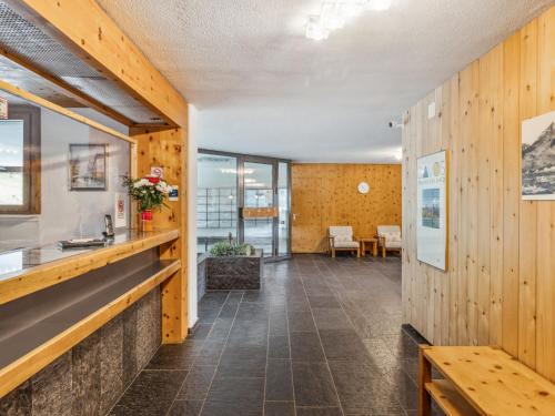 a hallway with wood paneling and a dining room at Apartment Guardaval - Utoring-5 by Interhome in Davos