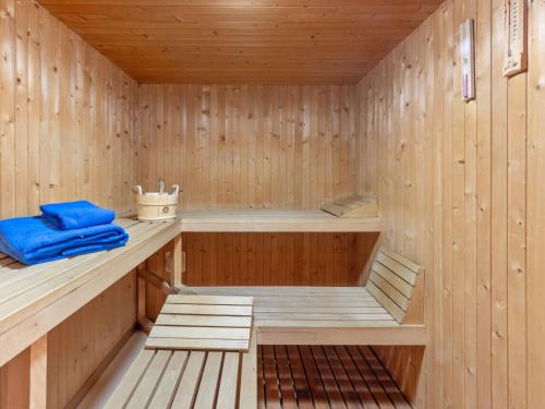 a wooden sauna with a blue towel sitting in it at Apartment Parkareal - Utoring-13 by Interhome in Davos