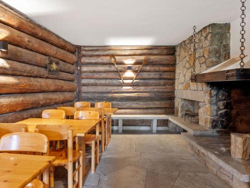 a restaurant with wooden walls and wooden tables and chairs at Apartment Parkareal - Utoring-13 by Interhome in Davos