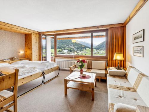 a hotel room with a bed and a large window at Apartment Guardaval Apt 202 by Interhome in Davos