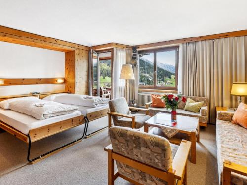 a bedroom with a bed and a living room at Apartment Guardaval Apt 508 by Interhome in Davos
