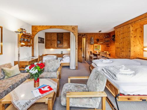 a living room with two beds and a couch at Apartment Guardaval Apt 508 by Interhome in Davos