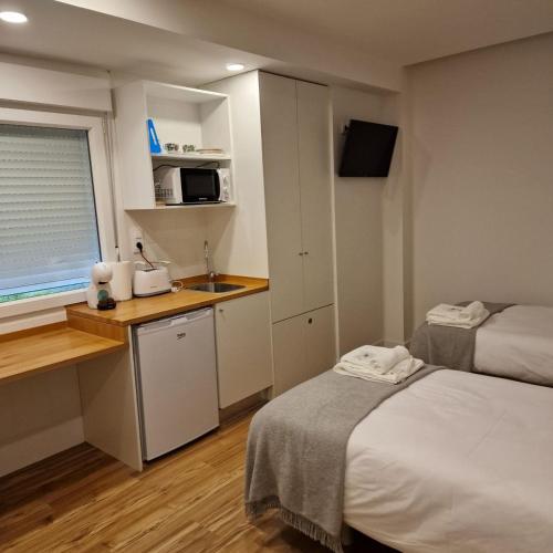 Una cama o camas en una habitación de Alojamientos Cando