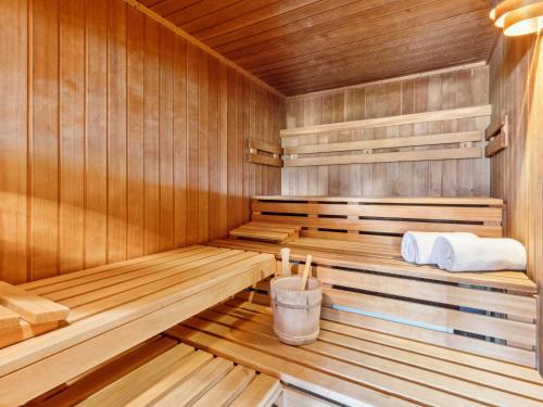 a sauna with wooden walls and wooden flooring at Apartment Guardaval - Utoring-36 by Interhome in Davos