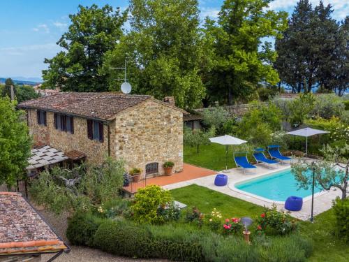 an external view of a stone house with a swimming pool at Holiday Home Ambrogetta by Interhome in San Casciano in Val di Pesa