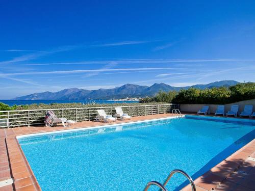 a swimming pool with a view of the mountains at Apartment Suarella-2 by Interhome in Saint-Florent