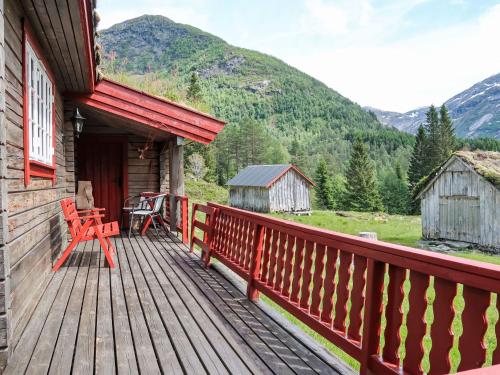 a deck of a cabin with a table and chairs at Chalet Fjellbris by Interhome in Holsen