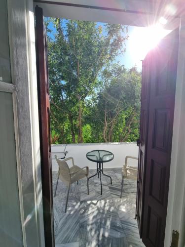a door open to a patio with a table and chairs at petrADi in Petra