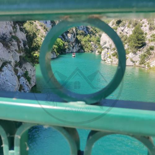 a view of a river with a boat in the water at Côté Verdon in Quinson
