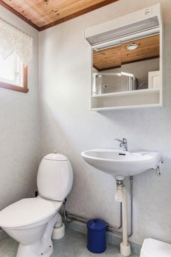 a bathroom with a toilet and a sink at Holiday Home Matvikshamn by Interhome in Trensum