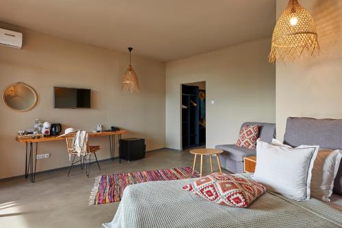 a living room with a bed and a couch at Sunny Beach Club - Adults Only #YouthfulVibes in Sunny Beach