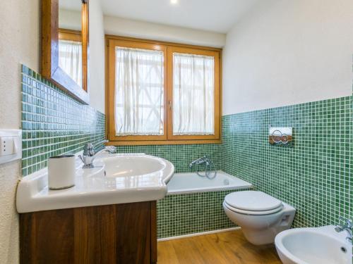 a bathroom with a sink and a toilet and a tub at Holiday Home Policleto by Interhome in Santo Stefano A Tizzano