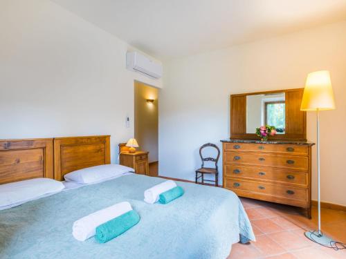 a bedroom with two beds and a dresser and a mirror at Holiday Home Policleto by Interhome in Santo Stefano A Tizzano