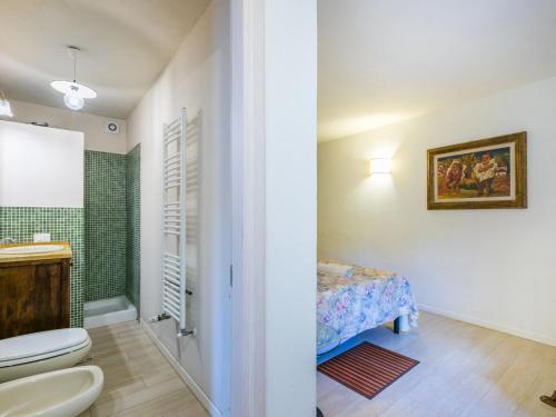 a bathroom with a toilet and a bed in a room at Holiday Home Policleto by Interhome in Santo Stefano A Tizzano