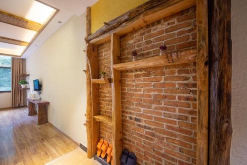 a brick wall in the hallway of a house at Hongfu Villa - Zhangjiajie National Forest Park West Gate in Zhangjiajie