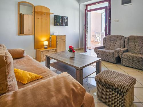 a living room with a couch and a table at Apartment Branko by Interhome in Sveti Juraj