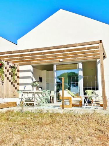 a house with a patio with a table and chairs at Meco Lodge Private Pool Full of Grace in Sesimbra