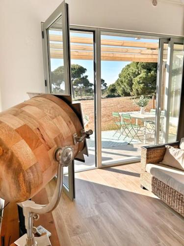 a large wooden barrel in a living room with a table at Meco Lodge Private Pool Full of Grace in Sesimbra