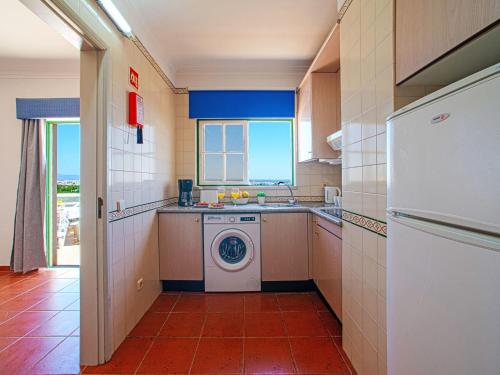 a kitchen with a washing machine and a washer at Apartment Estrela do Vau Apart- 3 bedroom-3 by Interhome in Portimão