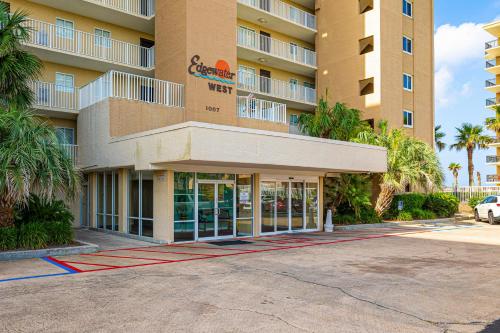 a building with a parking lot in front of it at Edgewater West Condos in Gulf Shores