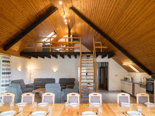 a living room with a loft with a spiral staircase at Holiday Home Eifelnatur - Haus 2-4 by Interhome in Immerath