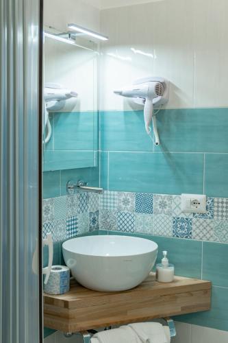 a bathroom with a white sink and a shower at Hotel Fontana in Amalfi