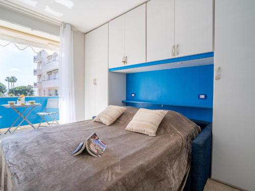 une chambre avec un grand lit avec une tête de lit bleue dans l'établissement Apartment Le Marlyne 1 by Interhome, à Cannes