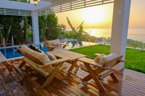 a patio with a table and chairs on a deck at Villa Aleph-Kiralık Müstakil havuzlu lüx villa in Bodrum City