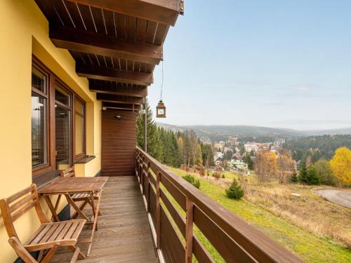 a balcony with a bench and a view of the mountains at Apartment Sachrův Kopec-1 by Interhome in Harrachov